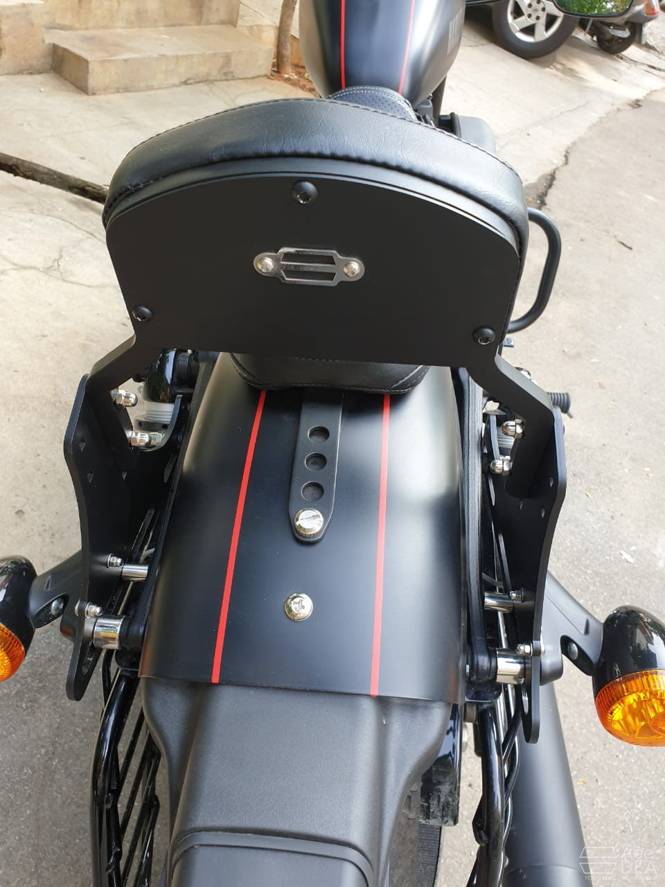 Rear view of the pillion backrest showing the mounting plates and fasteners