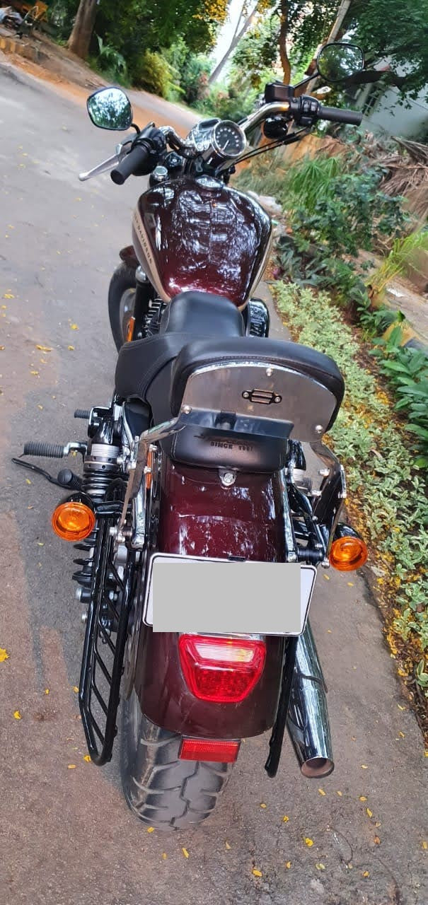Rear view of a motorcycle fitted with a pillion backrest and side luggage guards