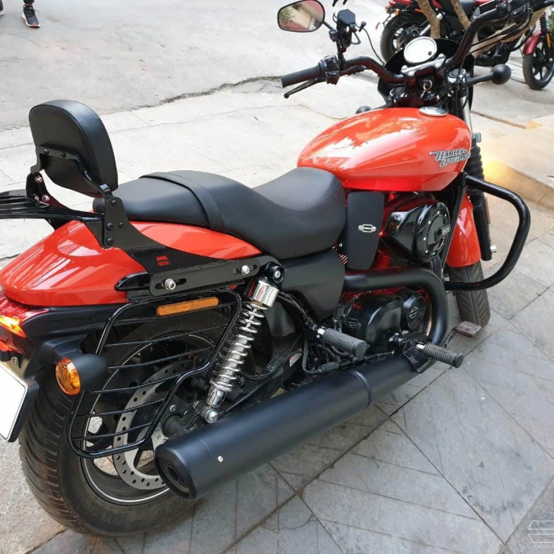 Side profile of a red motorcycle with black engine crash guard installed