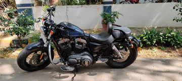 Rear three-quarter view of motorcycle with adjustable rider backrest