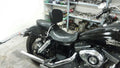 Black rider backrest installed behind the seat of a black cruiser motorcycle
