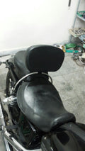 Rear view of a black motorcycle seat with an adjustable rider backrest installed