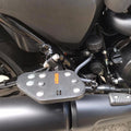 Close-up of motorcycle rider footboard showing its grip surface and mounting position