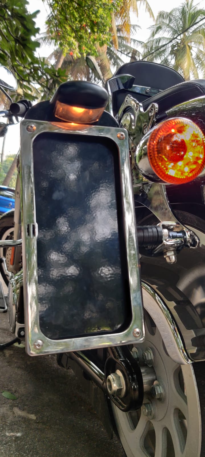 Close-up of the side number plate frame, mounting bracket and adjacent rear indicator