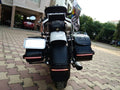 Rear view of a motorcycle with a side-mounted number plate and side luggage cases