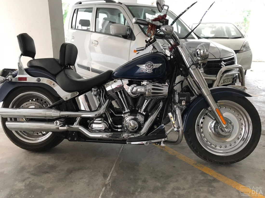 Side view of a blue cruiser motorcycle fitted with a rider backrest behind the front seat
