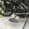 Close-up of a black Sports-style footboard mounted beside the motorcycle frame