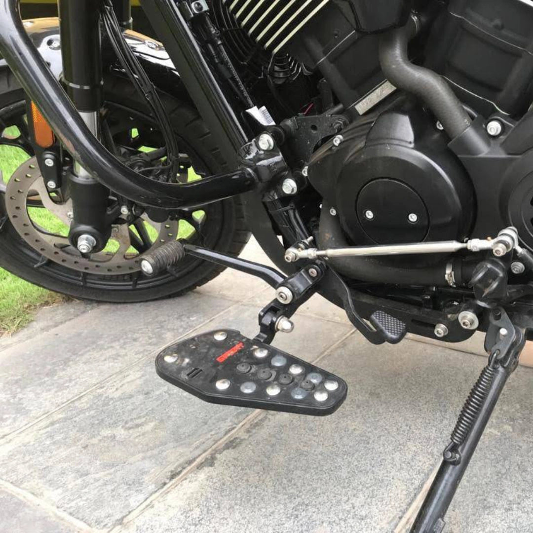 Close-up of a black Sports-style footboard mounted beside the motorcycle frame