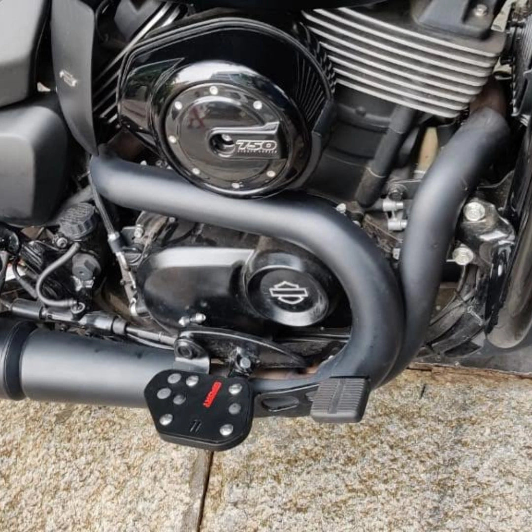 Close-up of a black Sports-style motorcycle footboard with contrasting grip inserts