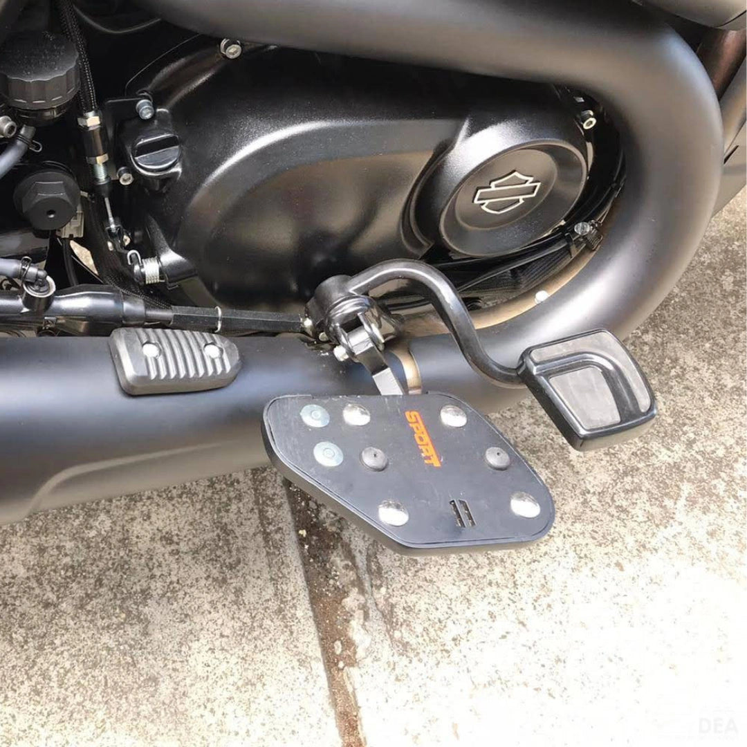 Close-up of Sports-style motorcycle rider footboard beside the engine