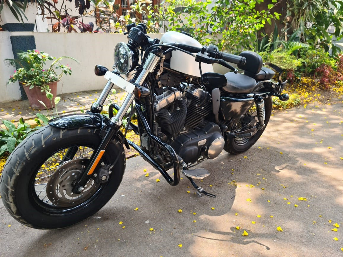 Harley-Davidson Sportster with a raised fuel tank and black tank raiser installed
