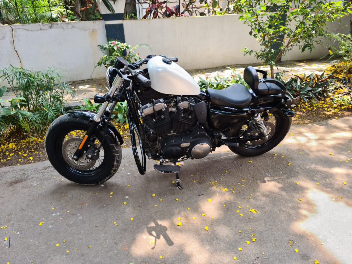 Harley-Davidson Sportster with a raised fuel tank and black tank raiser installed