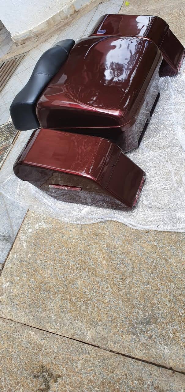Glossy maroon touring pannier boxes and black backrest viewed from above