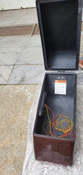 Open motorcycle pannier showing the black interior and LED wiring