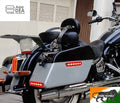 Close side view of touring motorcycle panniers with illuminated red LED strips