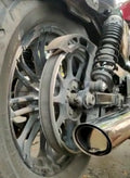Close-up of a stainless steel DB killer fitted at the outlet of a motorcycle exhaust