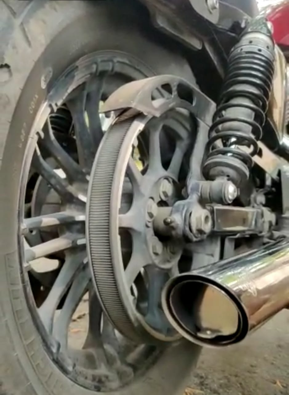 Close-up of a stainless steel DB killer fitted at the outlet of a motorcycle exhaust