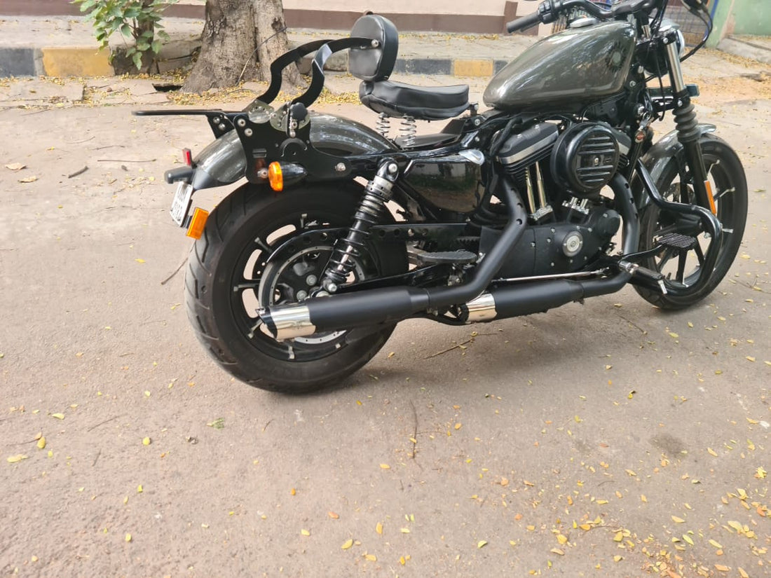 Close-up of AeeDEA black variable sound exhaust with metallic end caps installed on a motorcycle